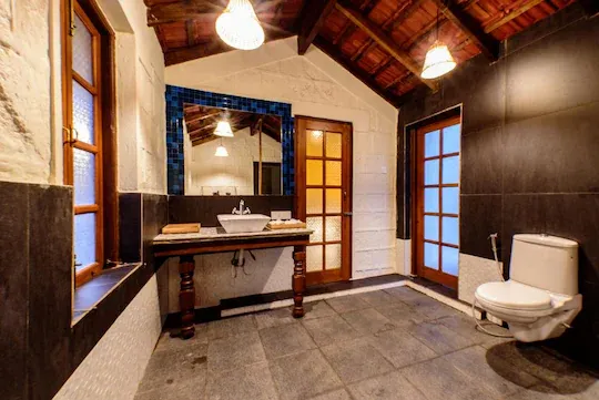 An attached bathroom with hand-plastered walls